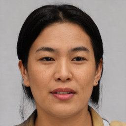 Joyful asian young-adult female with medium  brown hair and brown eyes