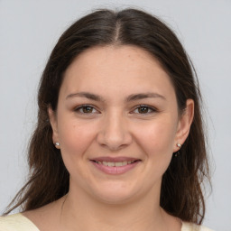 Joyful white young-adult female with medium  brown hair and brown eyes