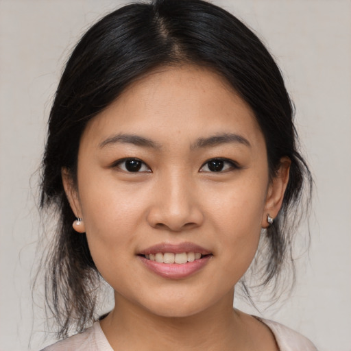Joyful asian young-adult female with medium  brown hair and brown eyes