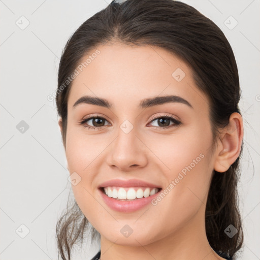 Joyful white young-adult female with medium  brown hair and brown eyes