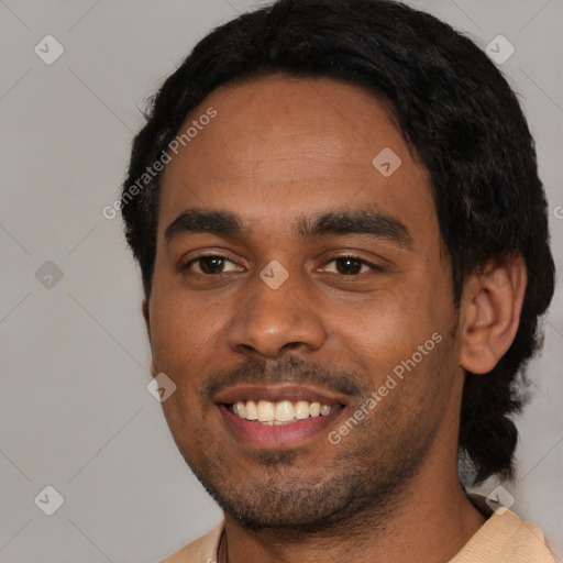 Joyful black young-adult male with short  black hair and brown eyes