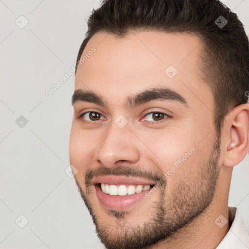 Joyful white young-adult male with short  brown hair and brown eyes