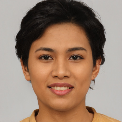 Joyful asian young-adult female with short  black hair and brown eyes