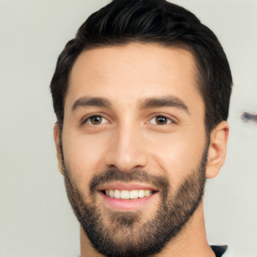 Joyful white young-adult male with short  black hair and brown eyes