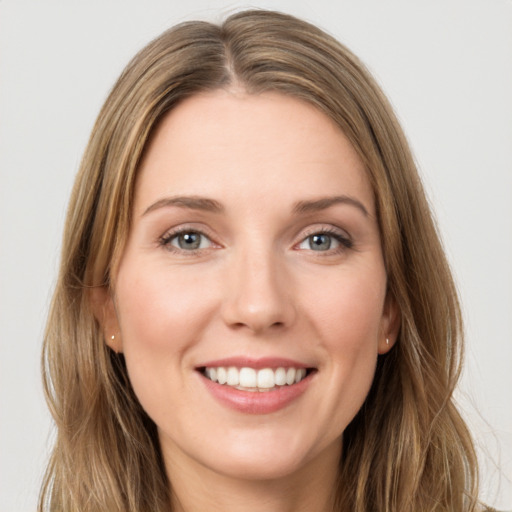 Joyful white young-adult female with long  brown hair and green eyes