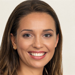 Joyful white young-adult female with long  brown hair and brown eyes