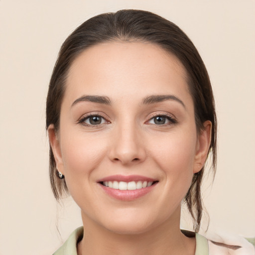 Joyful white young-adult female with medium  brown hair and brown eyes