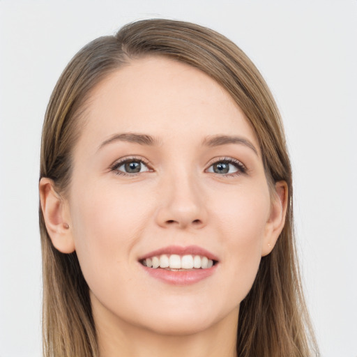 Joyful white young-adult female with long  brown hair and grey eyes