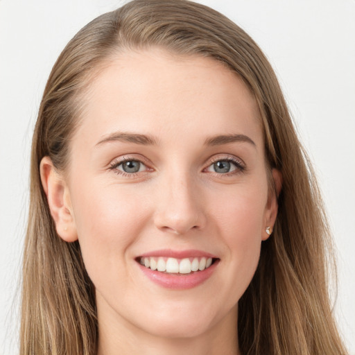 Joyful white young-adult female with long  brown hair and blue eyes