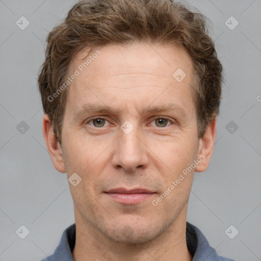 Joyful white adult male with short  brown hair and grey eyes