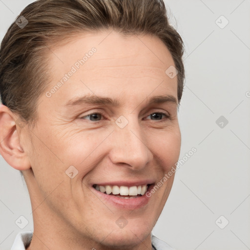 Joyful white adult male with short  brown hair and grey eyes