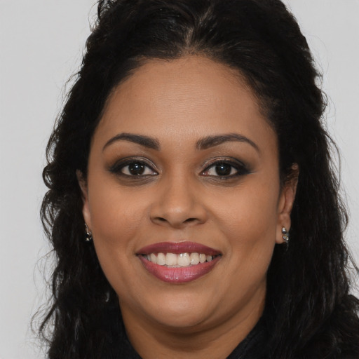 Joyful latino young-adult female with long  brown hair and brown eyes