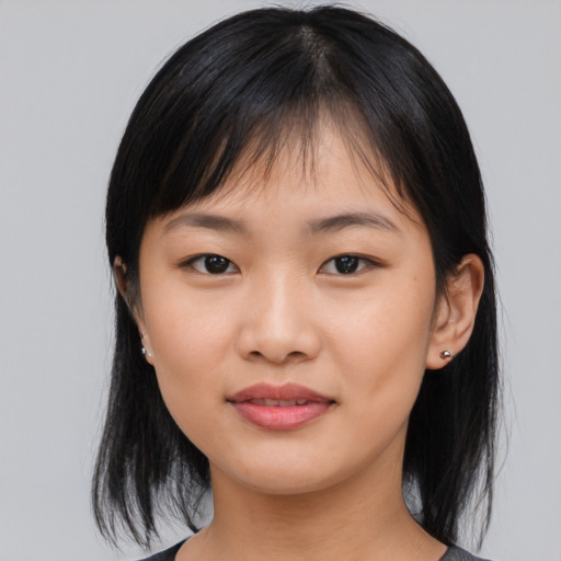 Joyful asian young-adult female with medium  black hair and brown eyes