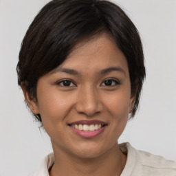 Joyful asian young-adult female with short  brown hair and brown eyes