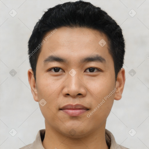 Joyful asian young-adult male with short  black hair and brown eyes