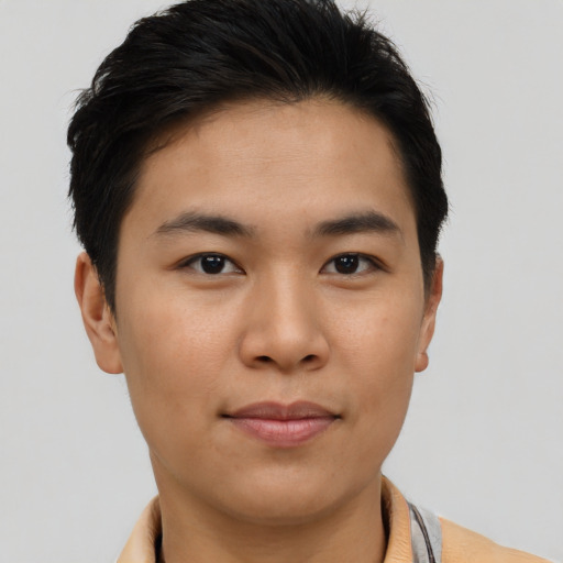 Joyful asian young-adult male with short  brown hair and brown eyes