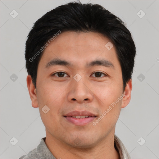 Joyful asian young-adult male with short  black hair and brown eyes