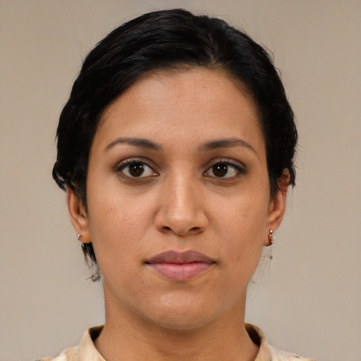 Joyful latino young-adult female with short  black hair and brown eyes