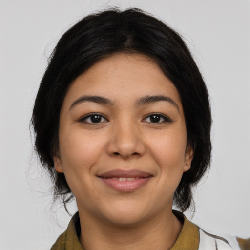Joyful latino young-adult female with medium  black hair and brown eyes
