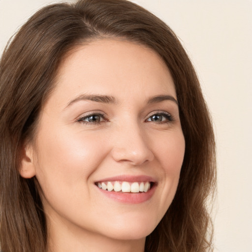 Joyful white young-adult female with long  brown hair and brown eyes