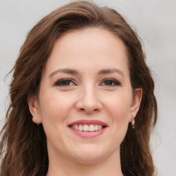 Joyful white young-adult female with long  brown hair and green eyes