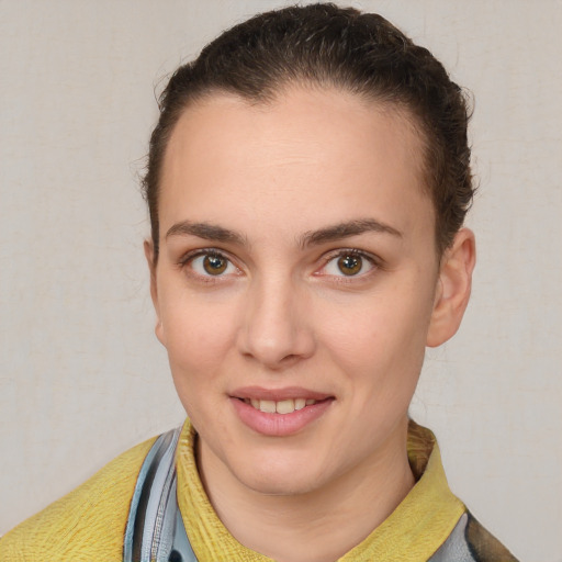 Joyful white young-adult female with short  brown hair and brown eyes