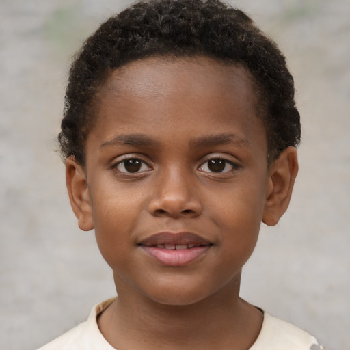 Joyful black child male with short  brown hair and brown eyes