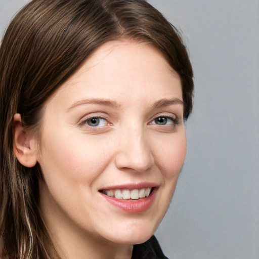 Joyful white young-adult female with long  brown hair and blue eyes