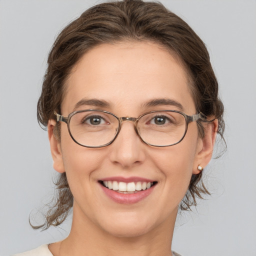 Joyful white adult female with medium  brown hair and brown eyes