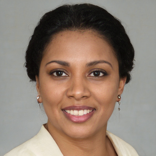 Joyful latino young-adult female with medium  brown hair and brown eyes