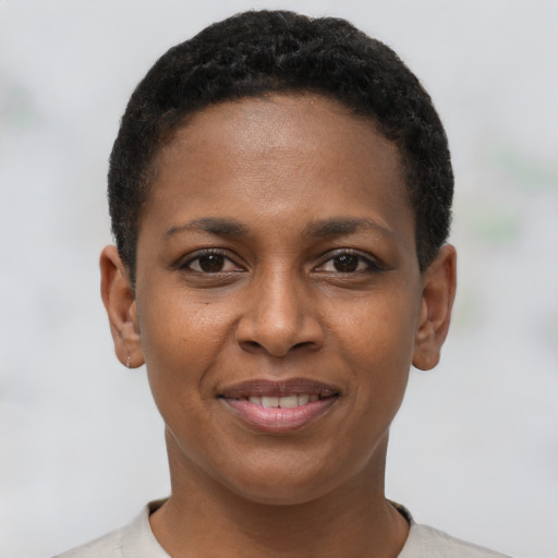 Joyful black young-adult female with short  brown hair and brown eyes
