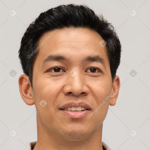 Joyful latino young-adult male with short  brown hair and brown eyes