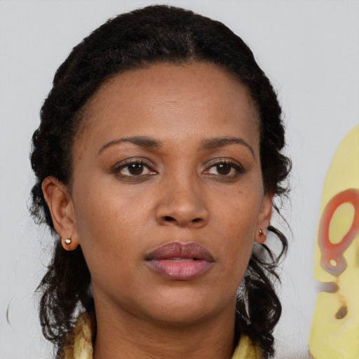 Neutral black young-adult female with medium  brown hair and brown eyes