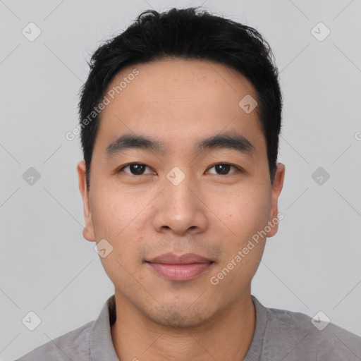 Joyful asian young-adult male with short  black hair and brown eyes