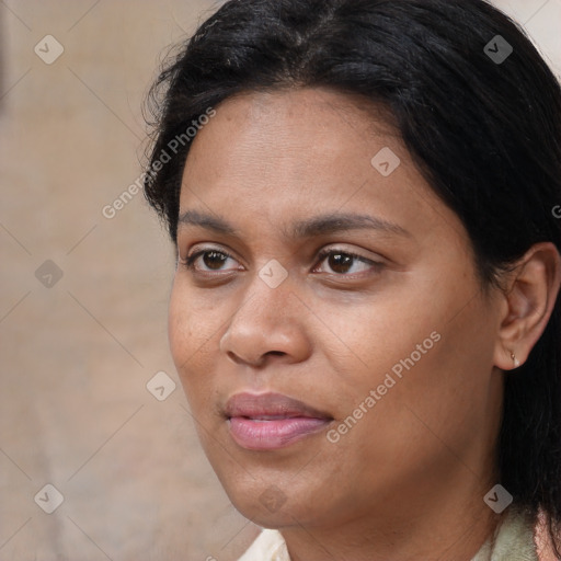 Joyful black adult female with medium  brown hair and brown eyes