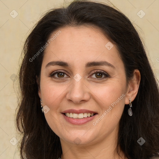 Joyful white adult female with long  brown hair and brown eyes