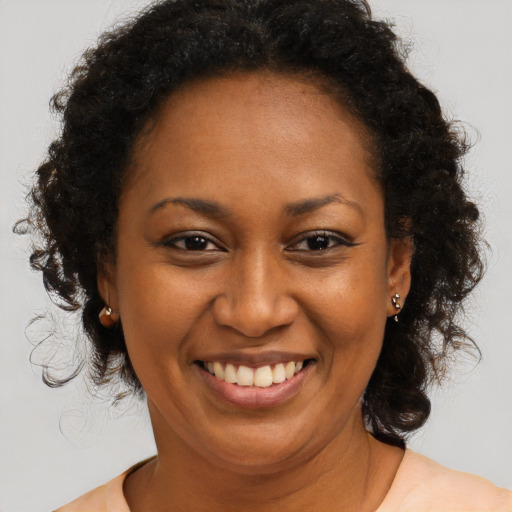 Joyful black adult female with long  brown hair and brown eyes