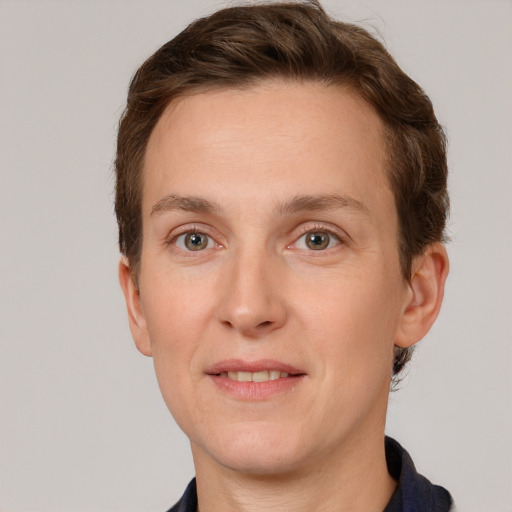 Joyful white adult male with short  brown hair and grey eyes