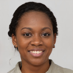 Joyful black young-adult female with medium  brown hair and brown eyes