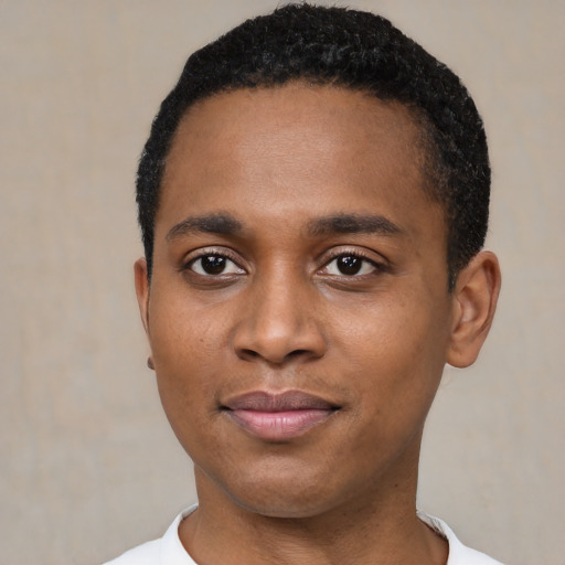Joyful black young-adult male with short  black hair and brown eyes