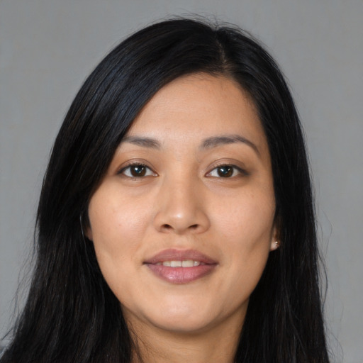 Joyful asian young-adult female with long  black hair and brown eyes