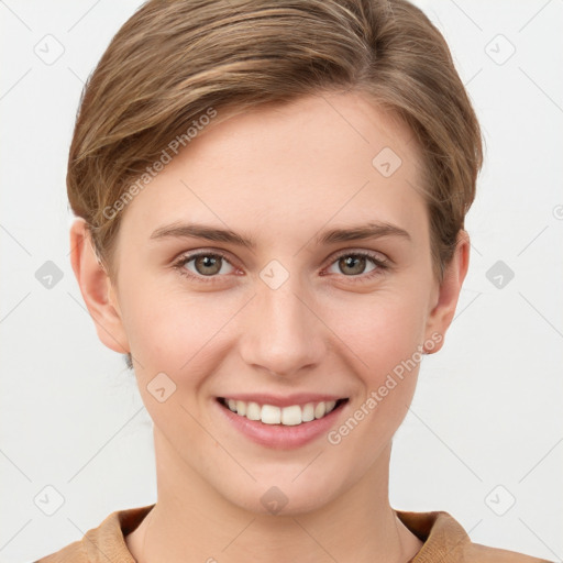 Joyful white young-adult female with short  brown hair and grey eyes