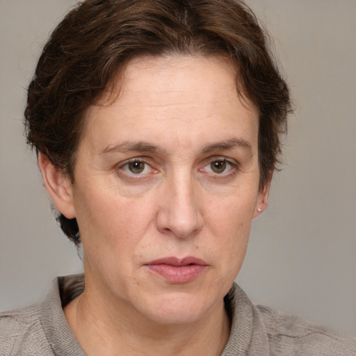 Joyful white adult female with short  brown hair and grey eyes