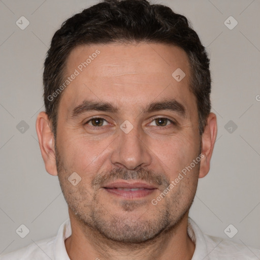 Joyful white adult male with short  brown hair and brown eyes