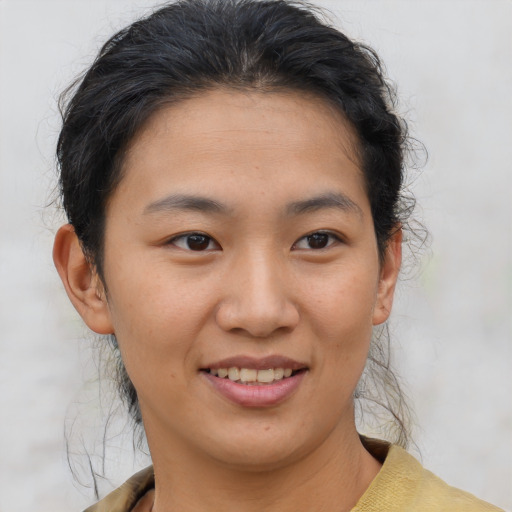 Joyful asian young-adult female with short  brown hair and brown eyes