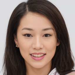 Joyful asian young-adult female with long  brown hair and brown eyes