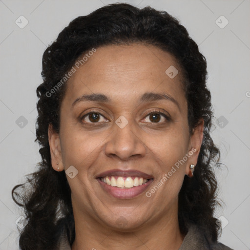 Joyful black adult female with long  brown hair and brown eyes