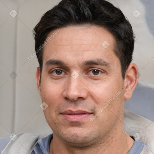 Joyful white adult male with short  brown hair and brown eyes