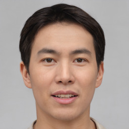 Joyful asian young-adult male with short  brown hair and brown eyes