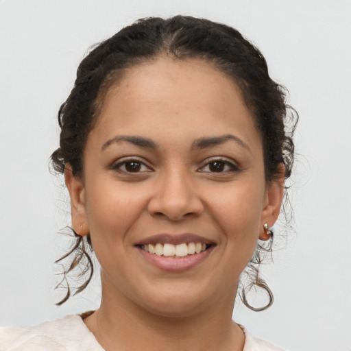 Joyful latino young-adult female with short  brown hair and brown eyes